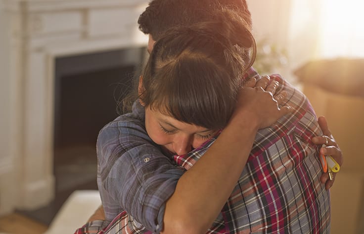 couple embracing after getting good news