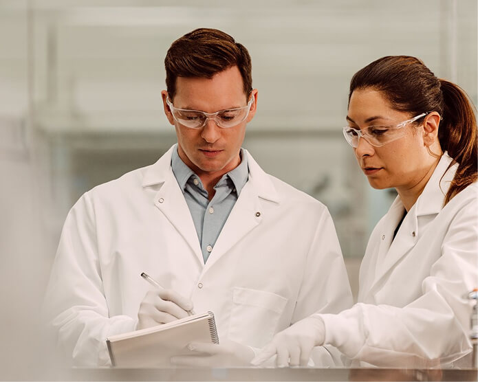 Scientists in lab reviewing data