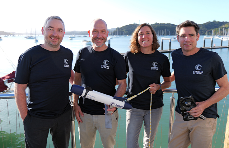 Evgeny Glazov of Illumina, Dr Xavier Pochon of Cawthron Institute, Erin Bomati of Citizens of the Sea and James Frankham of New Zealand Geographic with the TorpeDNA device and camera housing that will be used by citizen scientist sailors.